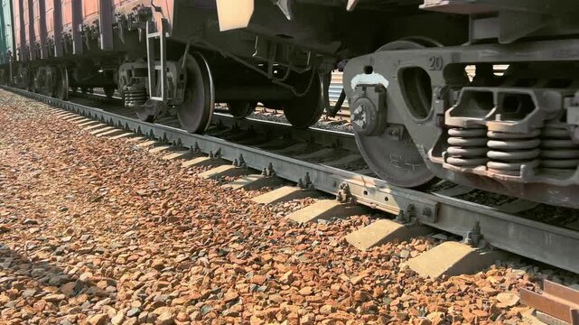 Freight train wheels and suspension rest on steel railway track