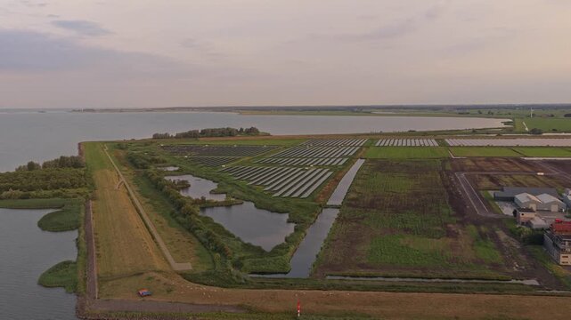 Aerial view of solar panels farm near lemmer ijsselmeer lake