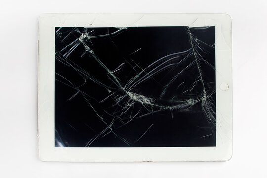Broken tablet with cracked screen showing technology failure