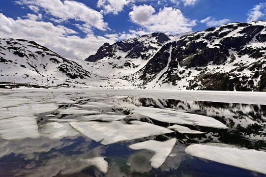 Ice floes float in the half-frozen Upper Murgsee, Murgtal, Canton of St. Gallen, Switzerland