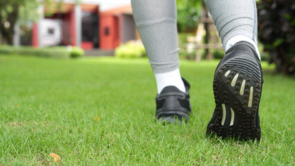Obraz premium Woman is walking exercise at the park