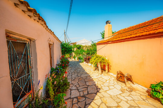Alley decorated with flowers in the picturesque village of Afionas vacation on the island of Corfu in Greece nearPorto Timoni beach