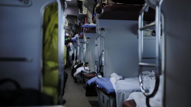 Long distance sleeper train corridor with multiple bunk beds and travel luggage