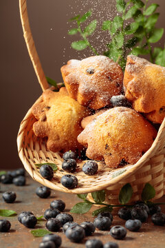 Freshly baked blueberry muffins in elegant basket.