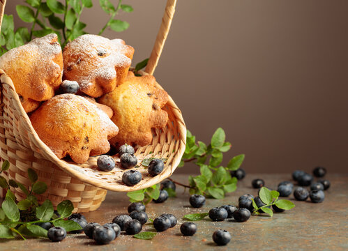 Freshly baked blueberry muffins in elegant basket.