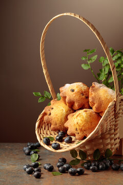 Freshly baked blueberry muffins in elegant basket.