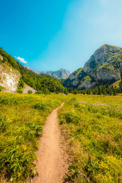 Alpine hiking trail from Prijevor in Bosnia to Trnovacko Lake in Montenegro, dramatic Dinaric Alps in Sutjeska park landscapes and crystal clear turquoise water.