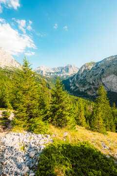 Alpine hiking trail from Prijevor in Bosnia to Trnovacko Lake in Montenegro, dramatic Dinaric Alps in Sutjeska park landscapes and crystal clear turquoise water.