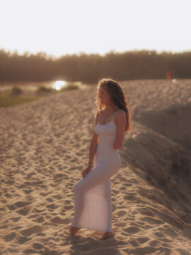 Amputee Woman Standing on Sand Dune at Sunset