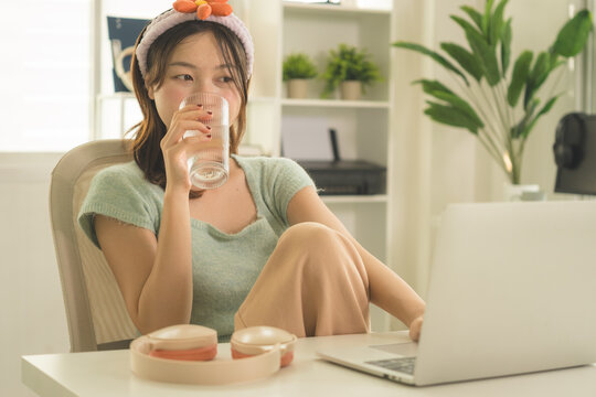 Young Asian Woman Working Online, Relaxing and Practicing Self Care During Daily Life at Home