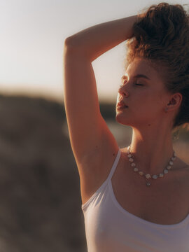 Close-up of Amputee Woman Standing on Sand Dune at Sunset