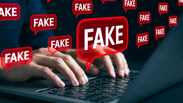 Person typing on laptop keyboard surrounded by red fake news speech bubbles depicting digital misinformation and internet fraud concept