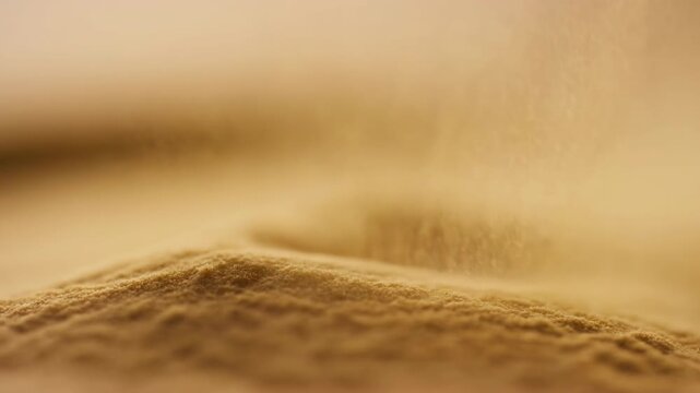 calm sand flows across the desert landscape under a serene sky with brown and beige tones, creating a peaceful and natural scene for in nature and editorial content.