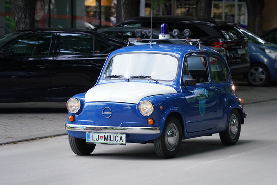 Zastava 750 (licensed Fiat 600) in blue and white Slovenian Milica (Milicija) police livery, with roof-mounted siren and classic details. Subotica, Serbia, June 6, 2026