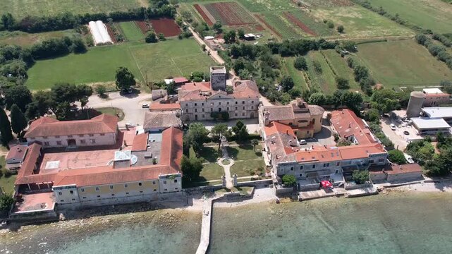 Aerial drone view of the historic abandoned Dajla monastery complex situated along the scenic Adriatic coast in Istria, Croatia.