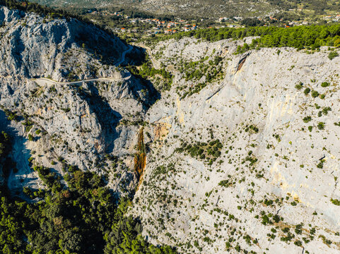 Aerial view of Omis city and the Cetina river canyon meeting the Adriatic sea, featuring historic Mirabella fortress and mountains, Dalmatia, Croatia
