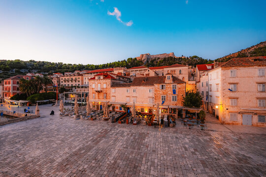 The grand St. Stephen's Square in Hvar town,  the Cathedral, the historic Arsenal, and elegant Venetian-style stone architecture, Croatia.