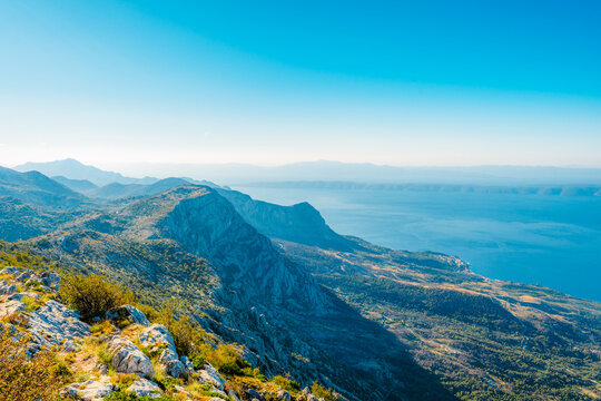 Panoramic view from Skywalk Biokovo glass platform overlooking Makarska Riviera, Adriatic sea and islands, Biokovo Nature Park, Croatia.