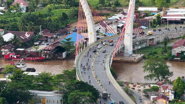 A view of Banjarmasin city and the Alalak River Bridge (or Basit Handil Bakti Bridge) in the late afternoon