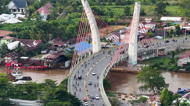 A view of Banjarmasin city and the Alalak River Bridge (or Basit Handil Bakti Bridge) in the late afternoon