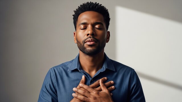 Man Meditating Calmly with Hands on Chest, Peaceful Expression, Inner Peace