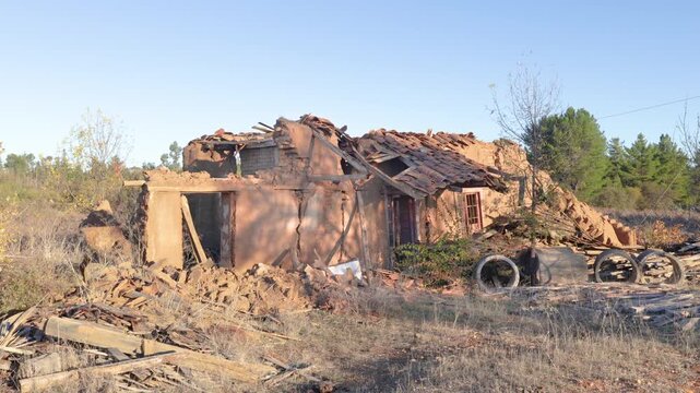 Old adobe house in ruins, located in a rural landscape of Chile, evoking history, abandonment, and the passage of time in traditional architecture.