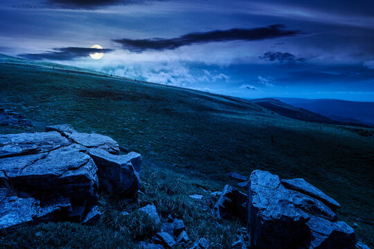 carpathian mountain landscape on summer night. mysterious background for outdoor adventure in the dark. transcarpathia green hill with rocks in foll moon light