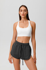 Fototapeta premium Fitness woman. Athletic girl on the gray background