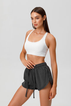 Fitness woman. Athletic girl on the gray background
