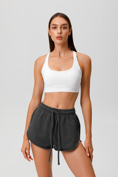 Fitness woman. Athletic girl on the gray background