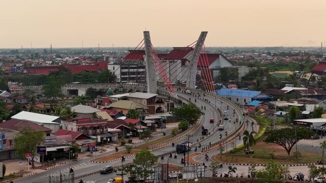 A view of Banjarmasin city and the Alalak River Bridge (or Basit Handil Bakti Bridge) in the late afternoon
