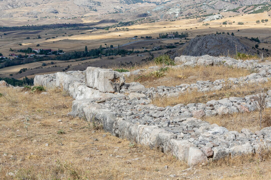 Ancient stone ruins at the archaeological site of Hattusa in Bogazkale, Turkey with scenic rural landscape