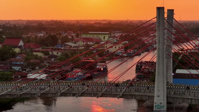 A view of Banjarmasin city and the Alalak River Bridge (or Basit Handil Bakti Bridge) in the sunset