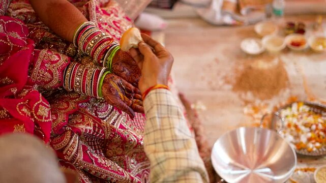 Indian bride hands with henna and bangles during traditional wedding ritual ceremony