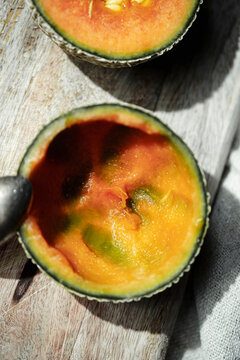 Sweet Melon Cut Open Showing Orange Flesh and Green Skin