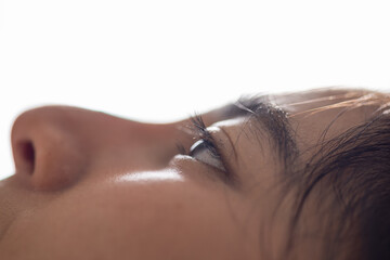 Face eye eyelash eyebrow nose skin profile closeup woman natural closeup profile portrait of calm female face with open eye, soft skin texture, dark hair, and bright minimal background © 220 Selfmade studio