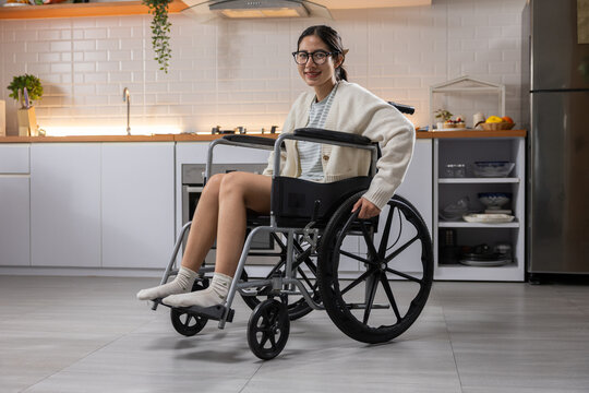 Wheelchair woman kitchen disability home smiling mobility indoor accessible independence woman using wheelchair smiles modern kitchen home showing mobility disability support independence
