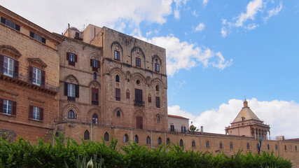Fototapeta premium Historic stone facade of Palazzo dei Normanni under a blue sky in Palermo, Sicily