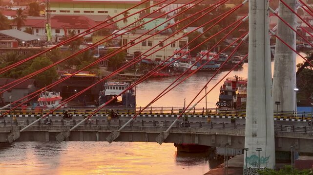 A view of Banjarmasin city and the Alalak River Bridge (or Basit Handil Bakti Bridge) in the sunset