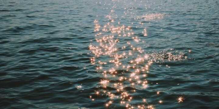 Sunlit sparkles dance on water.