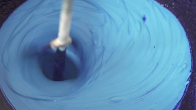Blue dye mixing with white paint for wall renovation