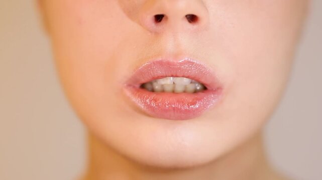 Close-up of young woman blowing a kiss
