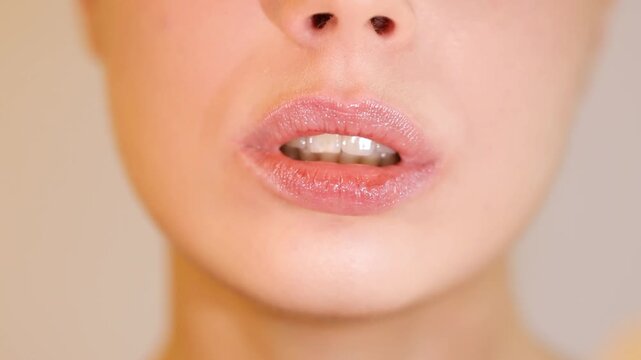 Close-up of young woman blowing a kiss