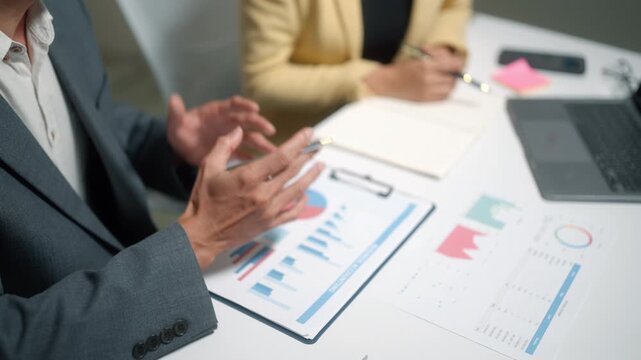 Business team analyzing financial charts in meeting