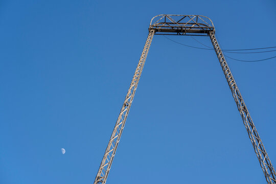 Blackpool, UK &ndash; May 24, 2026: Steel amusement ride tower framed with daytime moon