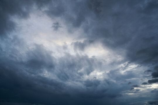 Dark Clouds rain storm and sun beam in storm. Dramatic sky background