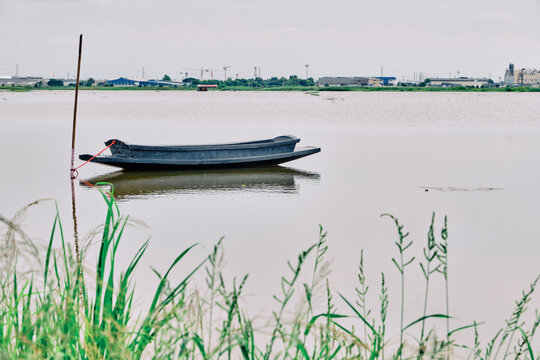 tranquil boat scene with riverside grasses