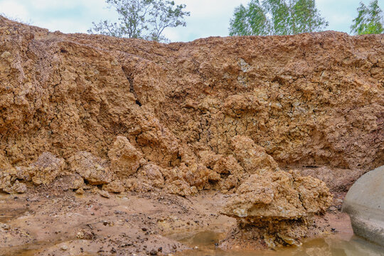 earth layers exposed under rainy sky mood