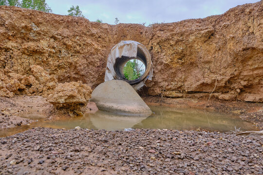 dry soil erosion around drainage pipe structure