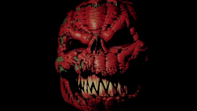 Aggressive Halloween Pumpkin Jump Scare Emerging from Darkness